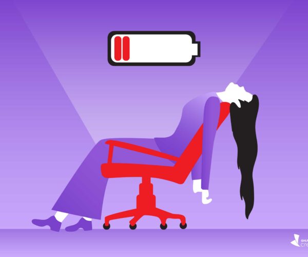 image shows an exhausted woman reclining in an office chair. There is a low-battery icon above her head