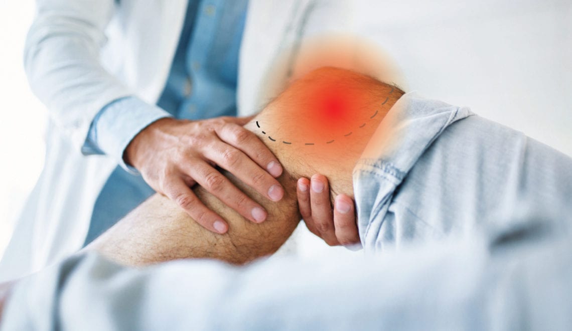 A doctor evaluating a person's knee, which is inflicted with knee osteoarthritis, as evident by a red pain spot.