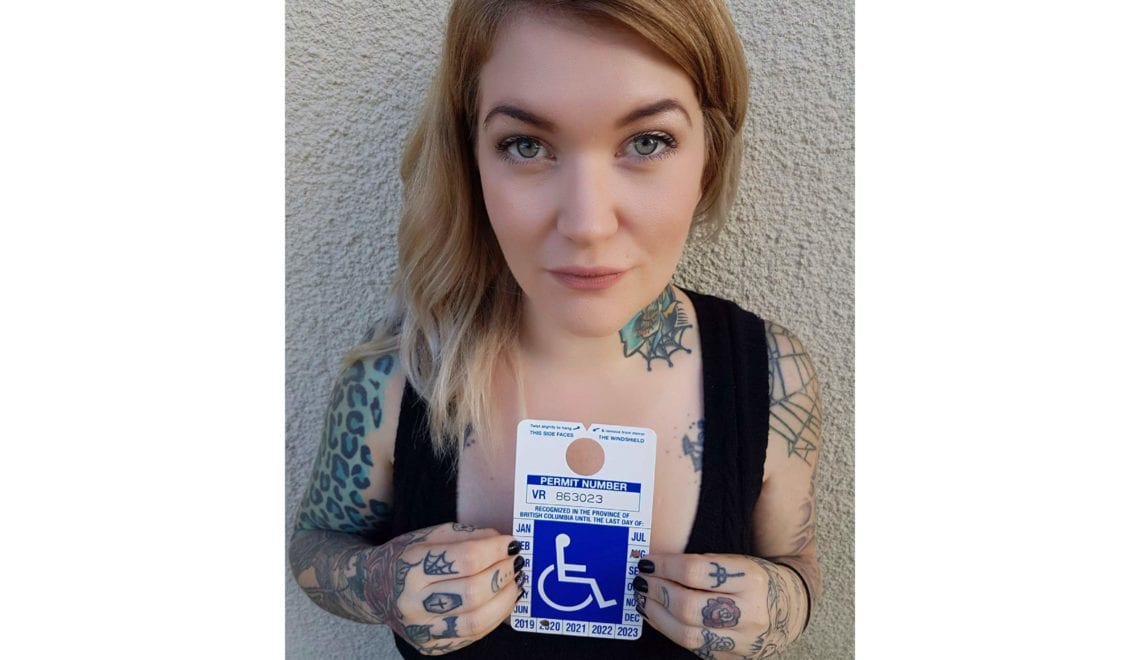 Photo of Eileen holding a handicapped placard