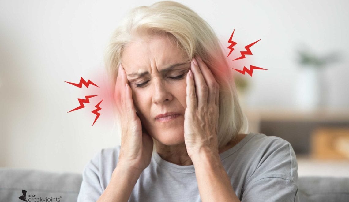 photo shows a woman holding her temples in pain. There is red and lightning bolts near her forehead