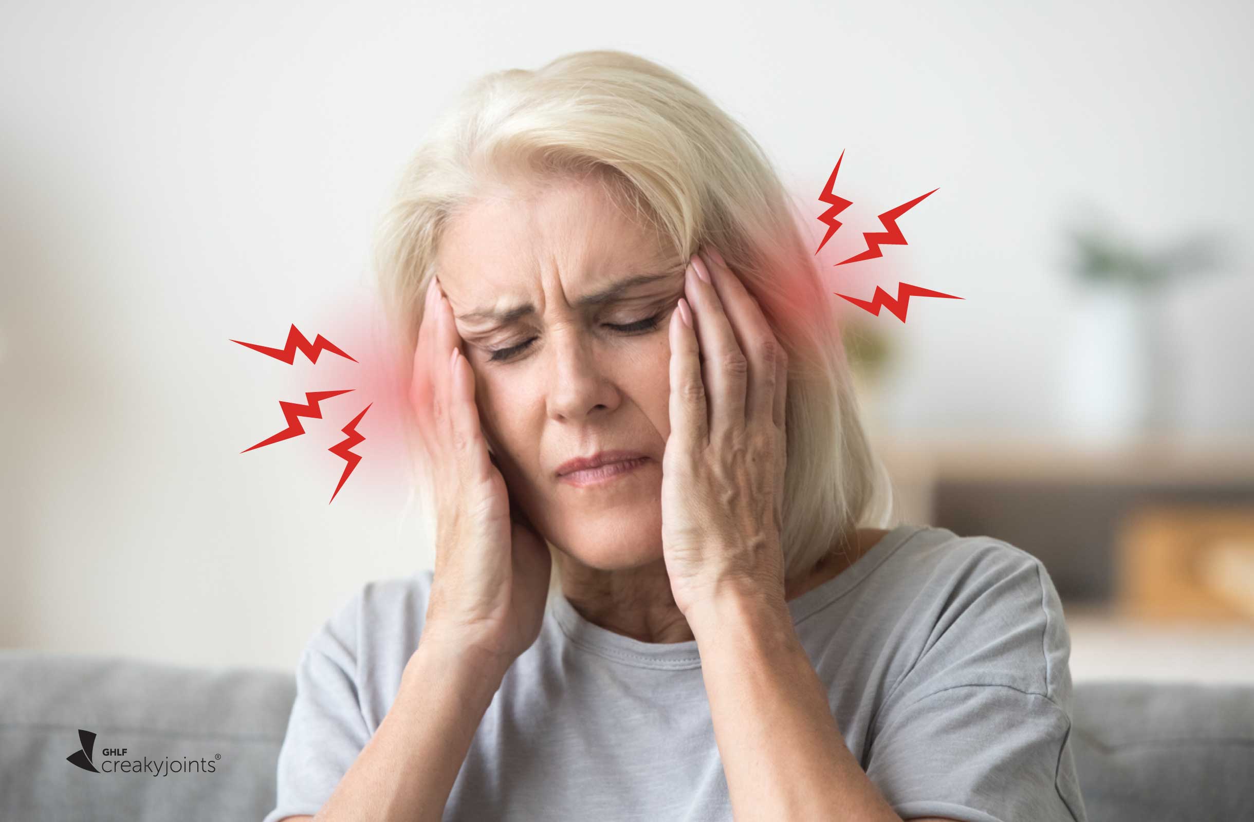 photo shows a woman holding her temples in pain. There is red and lightning bolts near her forehead