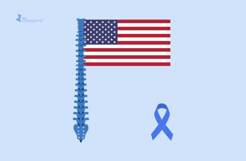 An American flag lays on a light blue background. The pole is a spine that has inflammation from axSpA. To the right of the flag is the blue spondyloarthritis awareness ribbon.