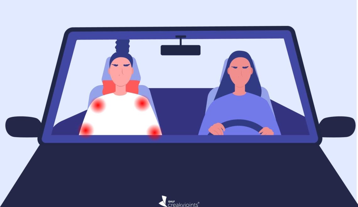 A person with arthritis, as evident by pain spots in their neck and arms in the passenger seat of a car. The person is resting their head against a pillow that is wrapped around the head rest