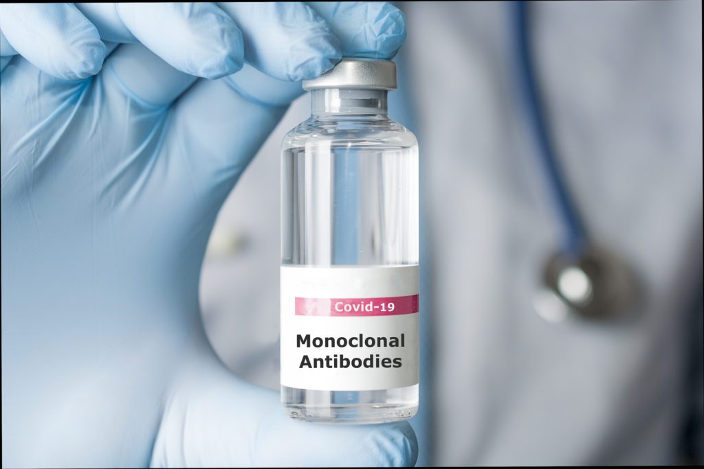 A photo of a doctor holding a vial of monoclonal antibodies, a new treatment for coronavirus Covid-19.