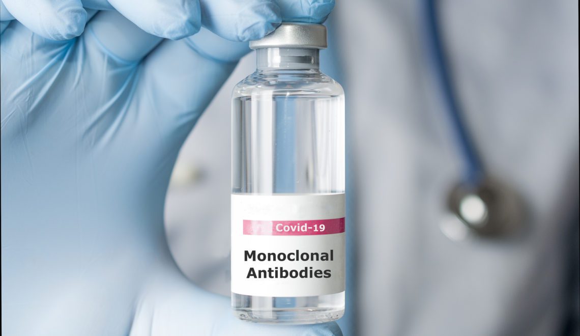 A photo of a doctor holding a vial of monoclonal antibodies, a new treatment for coronavirus Covid-19.