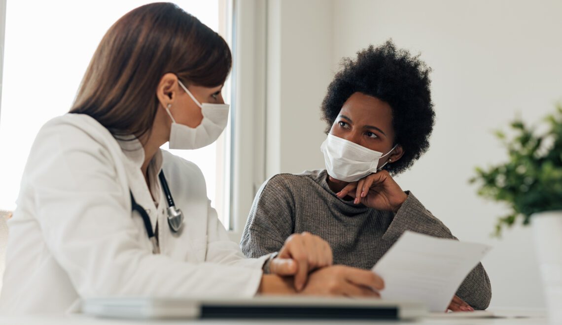 Woman patient and doctor wearing masks