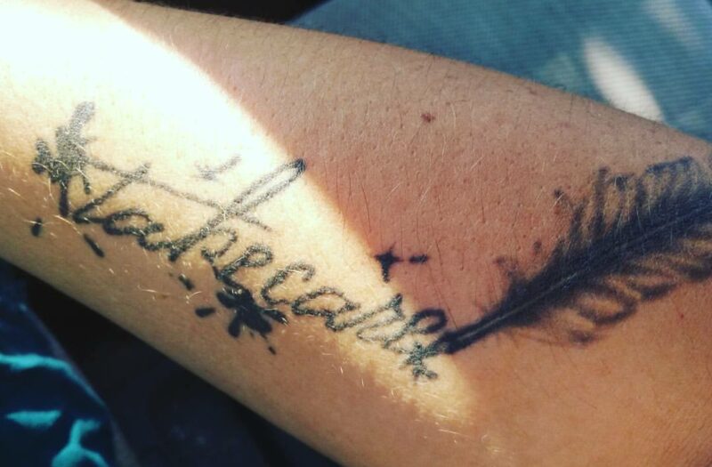 Angie Ebba's tattoo that reads "take care"