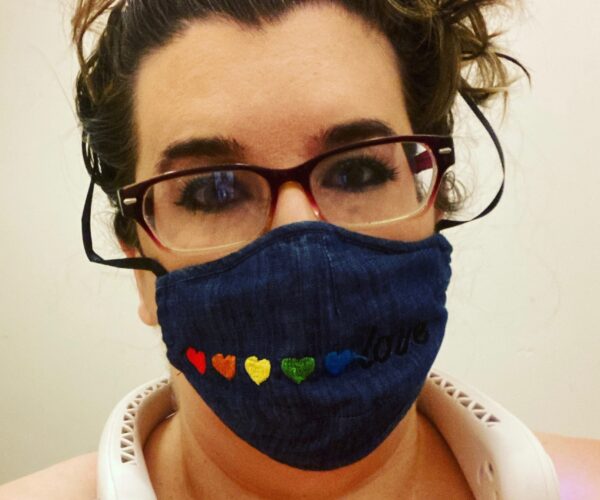 Angie Ebba pictured with neck fan and black mask with colorful hearts