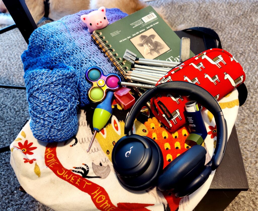 photo of headphones, yarn, fidgets for sensory kit