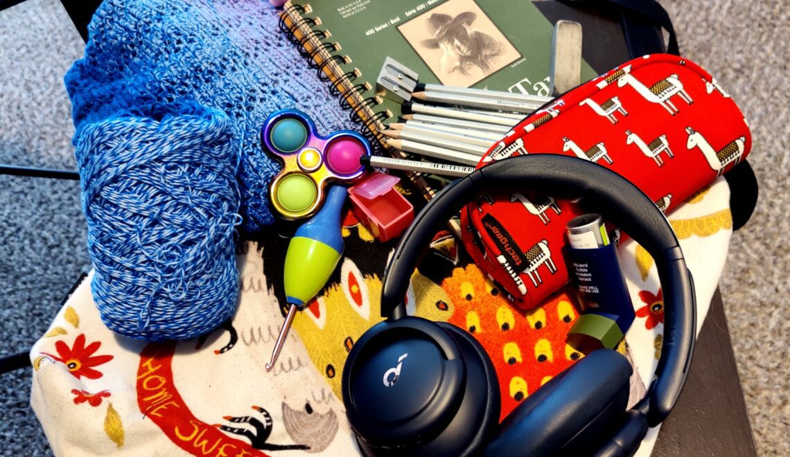 photo of headphones, yarn, fidgets for sensory kit